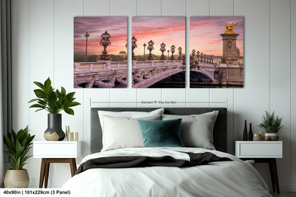 a bedroom with a bed and two paintings on the wall