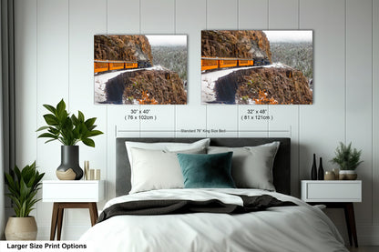 a bedroom with a bed and two pictures on the wall