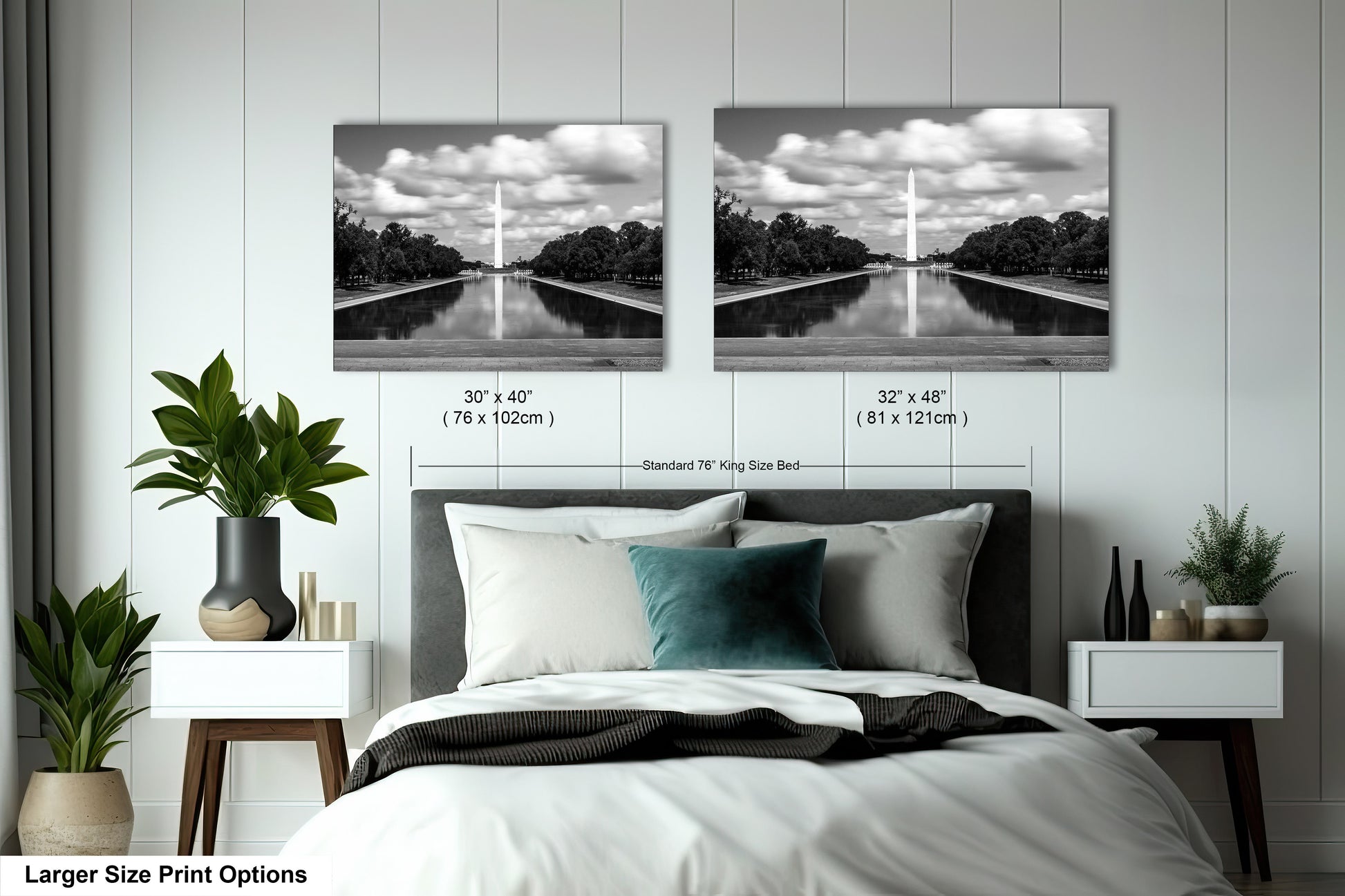 a bed with a white comforter and two black and white pictures on the wall