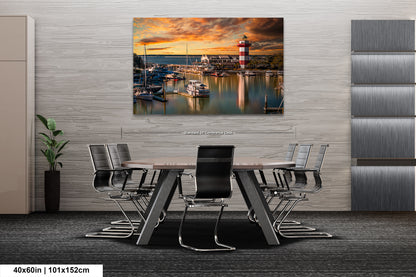 a dining room table with chairs and a painting of a lighthouse