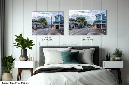 a bedroom with a bed and two pictures on the wall