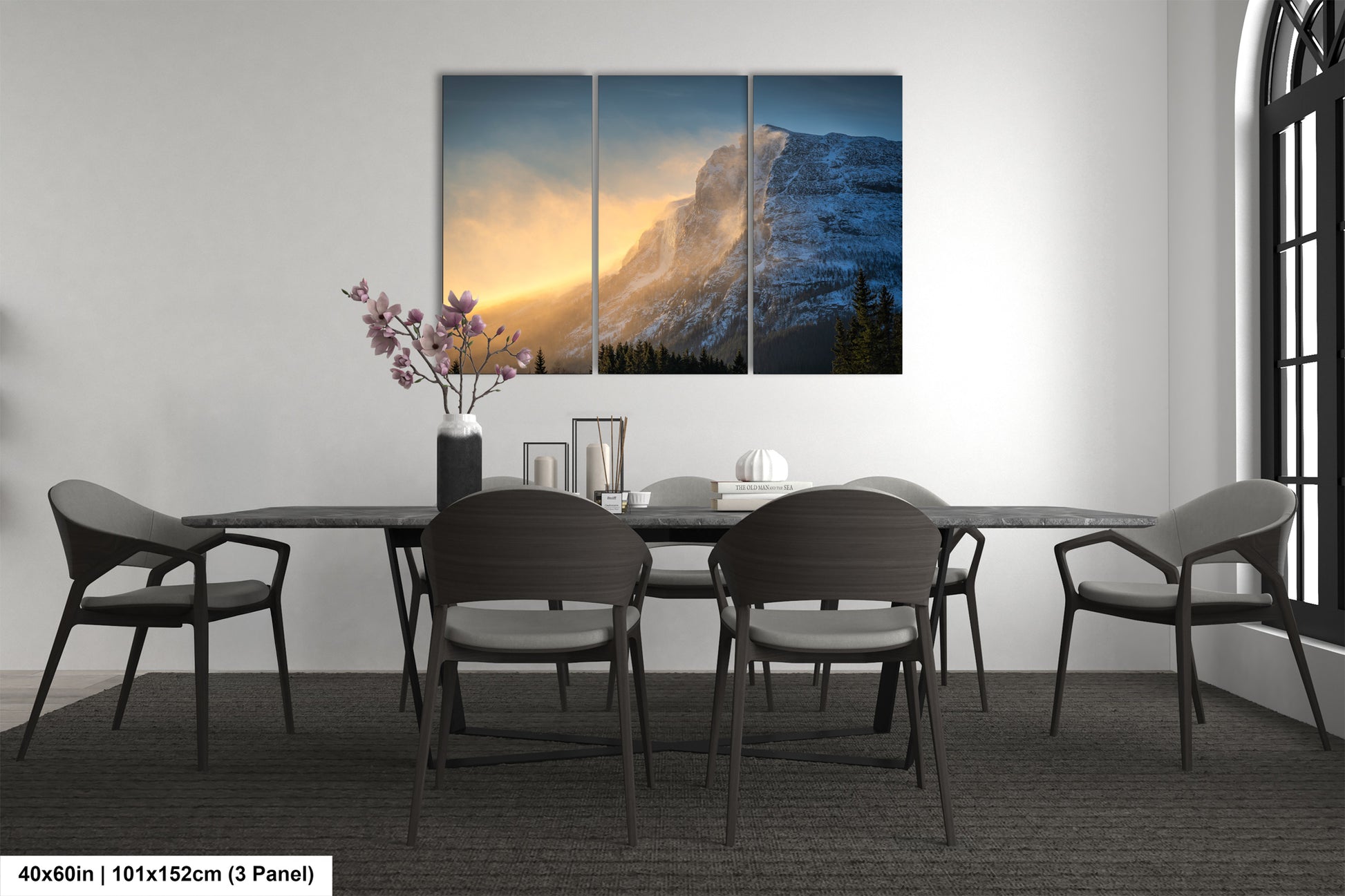 a dining room table with four chairs and a painting on the wall