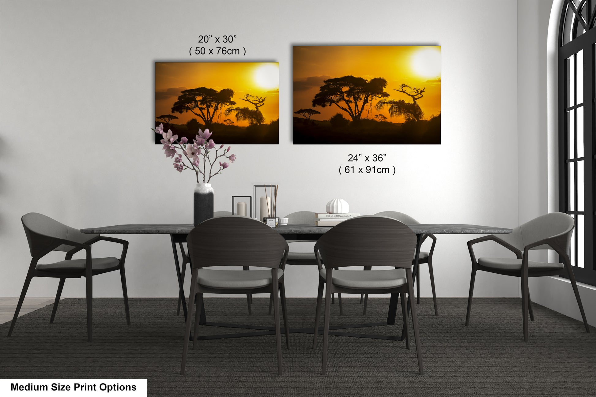 a dining table with four chairs and a vase of flowers