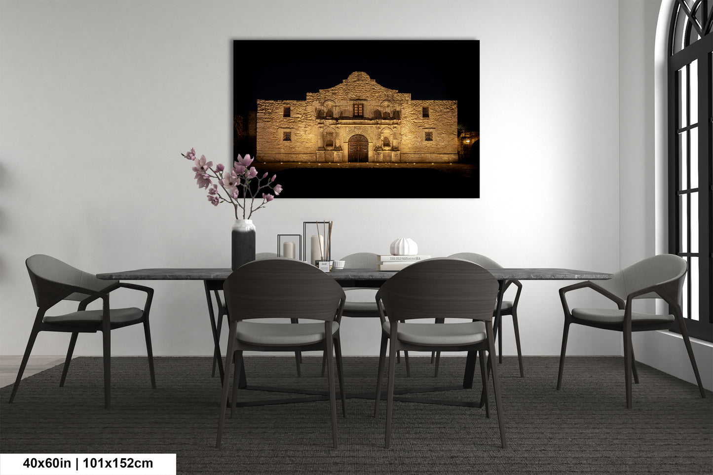 a modern dining room with a large framed photograph of the Alamo in the background, creating a focal point in the space.
