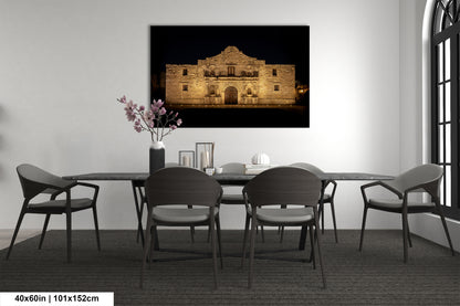 a modern dining room with a large framed photograph of the Alamo in the background, creating a focal point in the space.