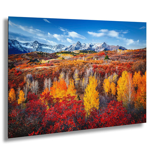 a scenic view of a mountain range in autumn