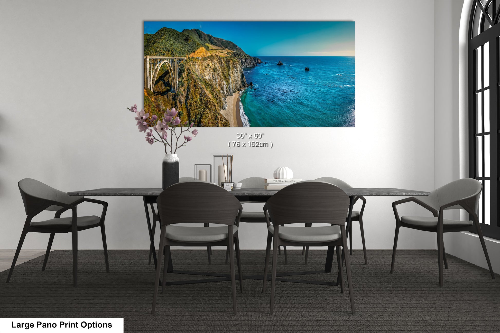 a dining room table with chairs and a painting on the wall