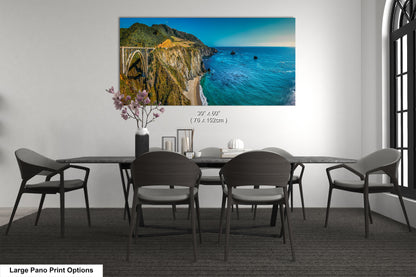 a dining room table with chairs and a painting on the wall