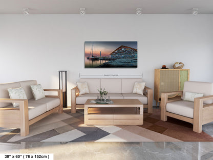 A modern living room with a large painting of a boat on the wall, a sofa, a coffee table, and a potted plant.