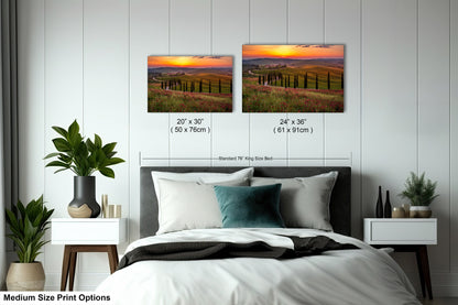 a bedroom with a bed and two pictures on the wall