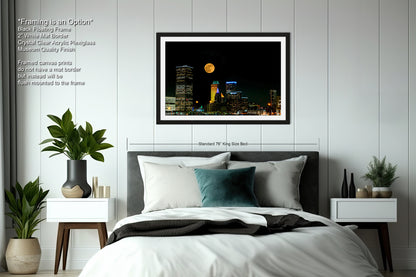 a picture of a bed with a city skyline in the background