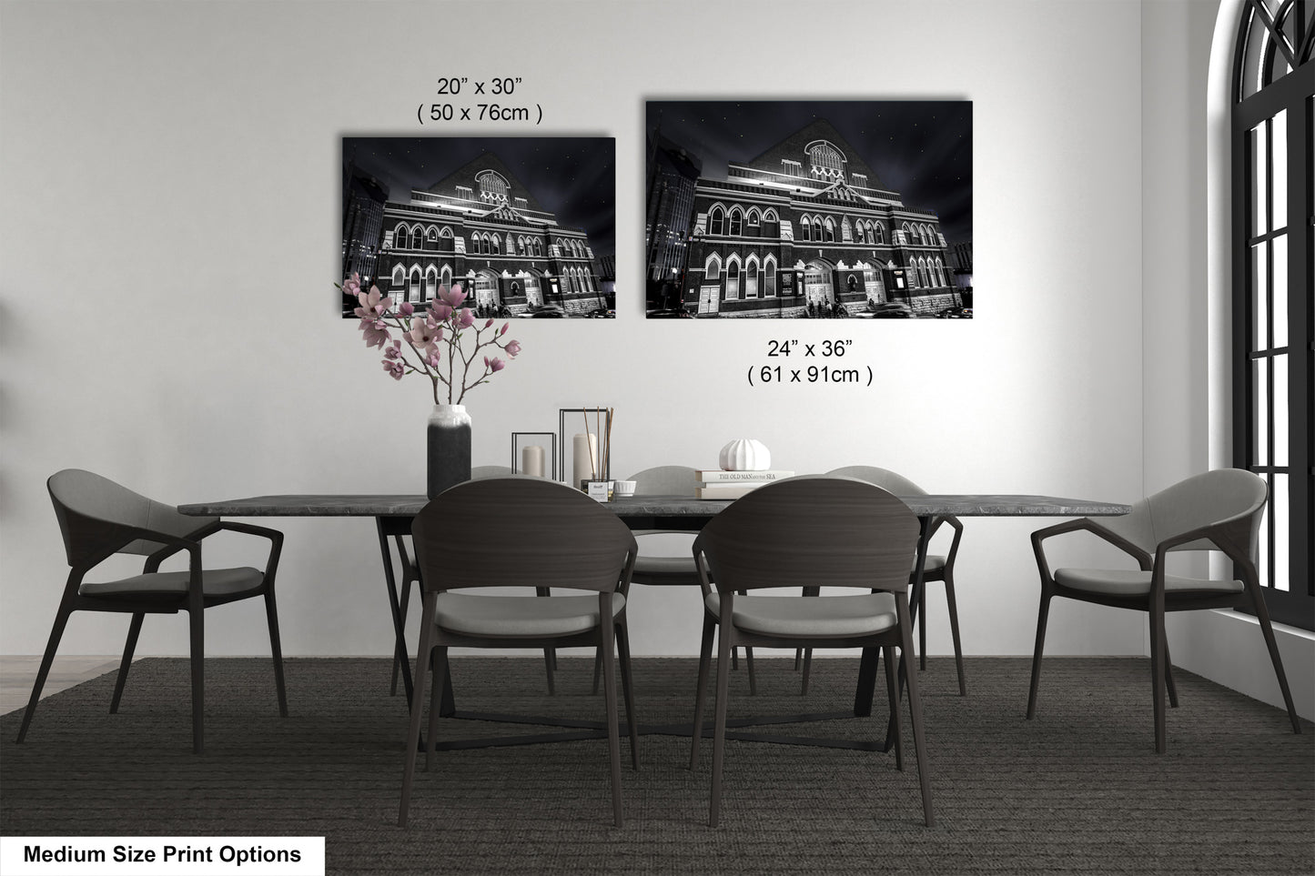 a dining table with four chairs and a vase of flowers