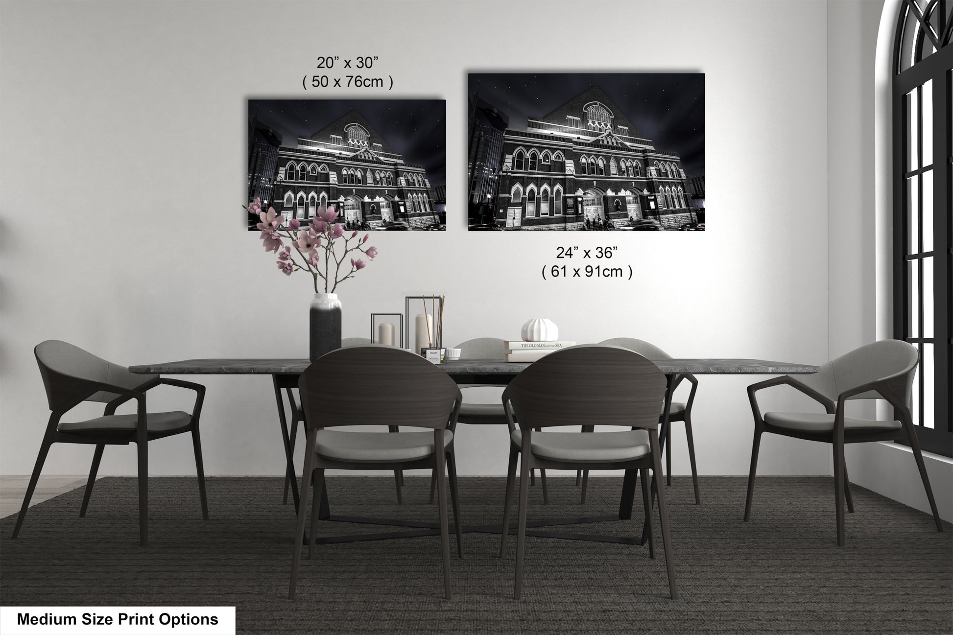 a dining table with four chairs and a vase of flowers