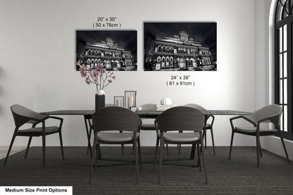 a dining table with four chairs and a vase of flowers