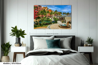 a bed room with a neatly made bed and a painting on the wall