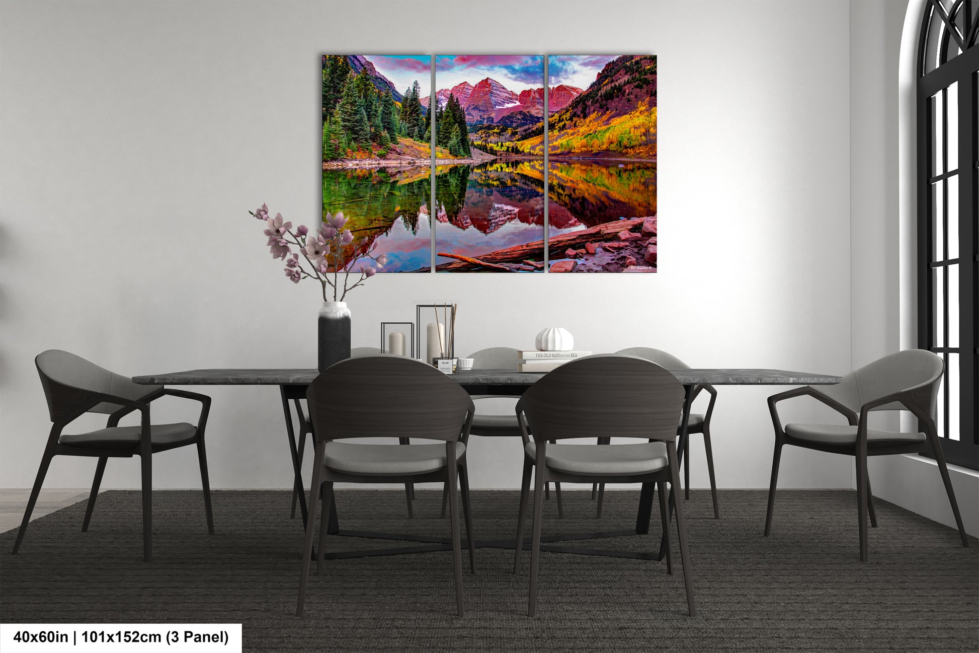 a dining room table with chairs and a painting on the wall