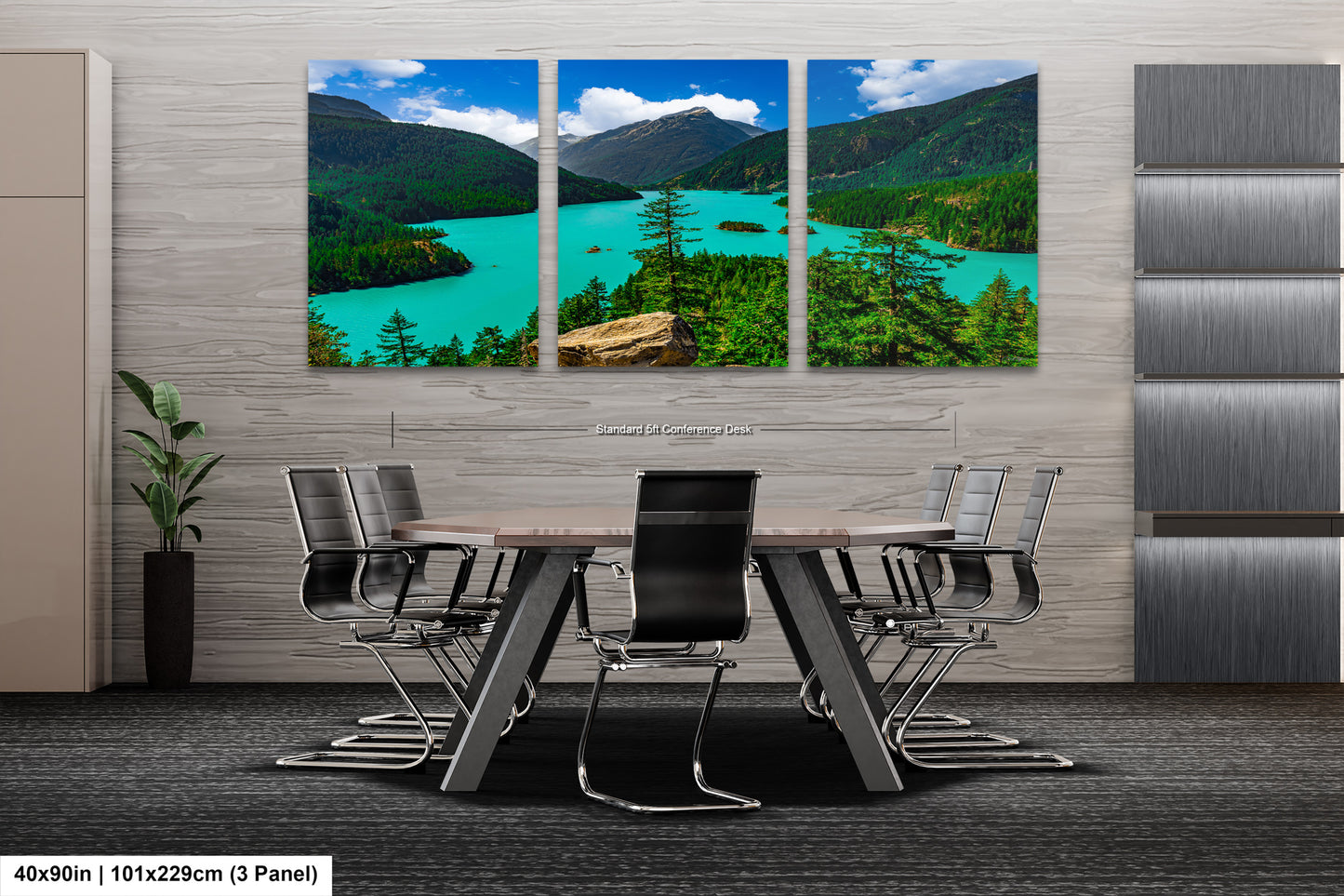 A modern office space with a large, three-panel landscape painting depicting a scenic mountain lake surrounded by forests. The painting is mounted on the wall above a wooden table with chairs.