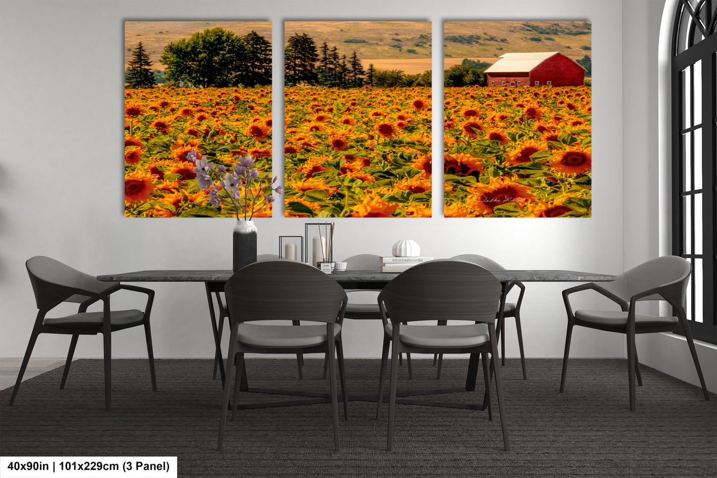 a dining room with a table and chairs and a picture of a sunflower field