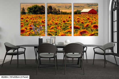 a dining room with a table and chairs and a picture of a sunflower field