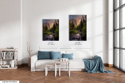 a living room with a white couch and two pictures on the wall