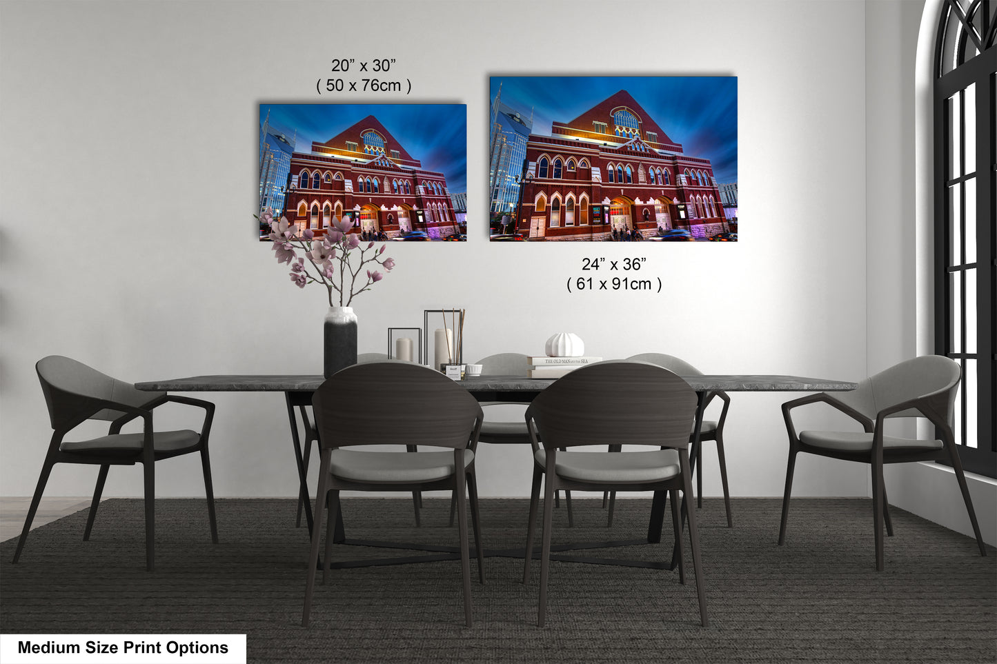 a dining table with four chairs and a vase of flowers