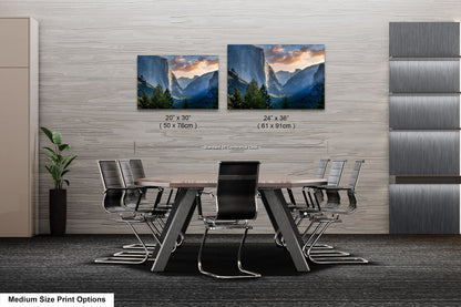 a dining room table with chairs and two pictures on the wall
