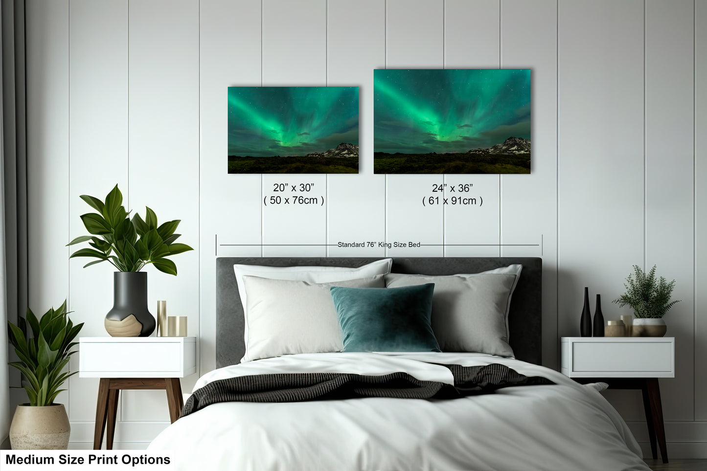 a bedroom with a bed and two pictures of the northern lights