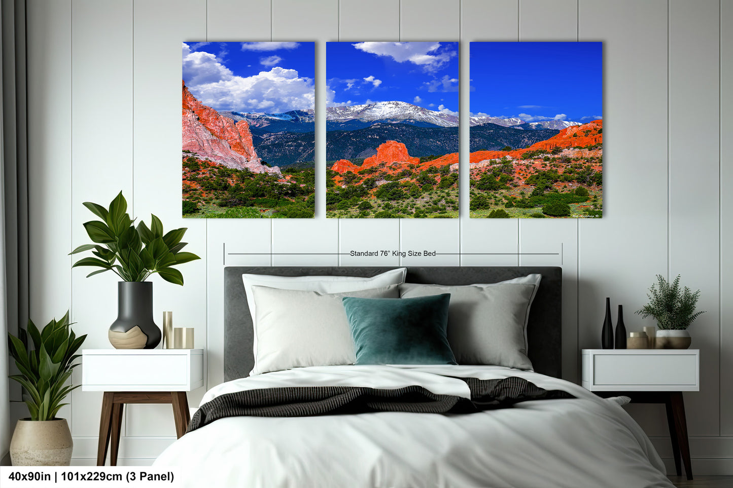 a bed room with a neatly made bed and two pictures on the wall