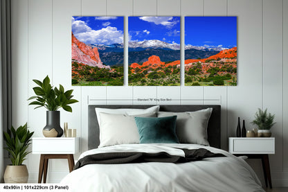 a bed room with a neatly made bed and two pictures on the wall