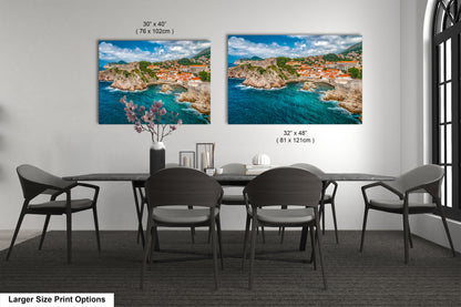a dining room table with four chairs and two pictures on the wall
