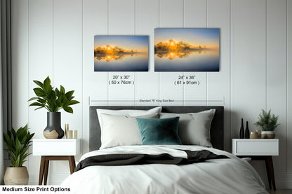 a bedroom with a bed and two pictures on the wall