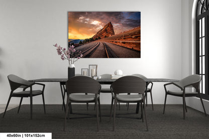 a dining room table with chairs and a painting on the wall