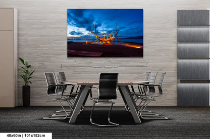 a dining room table with chairs and a painting on the wall