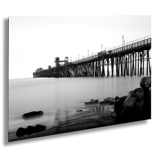 a black and white photo of a pier