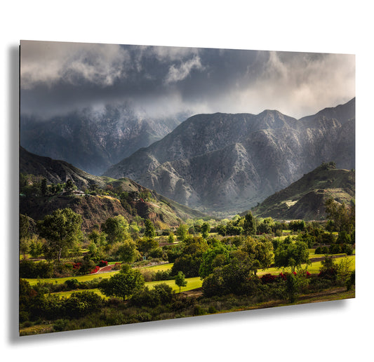 a scenic view of a mountain range under a cloudy sky