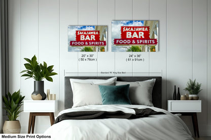 a bed room with a neatly made bed and two posters on the wall