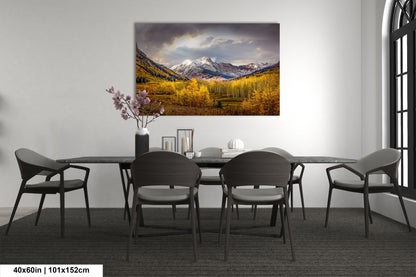 a dining room table with chairs and a painting on the wall