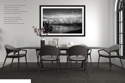 a black and white photo of a table and chairs