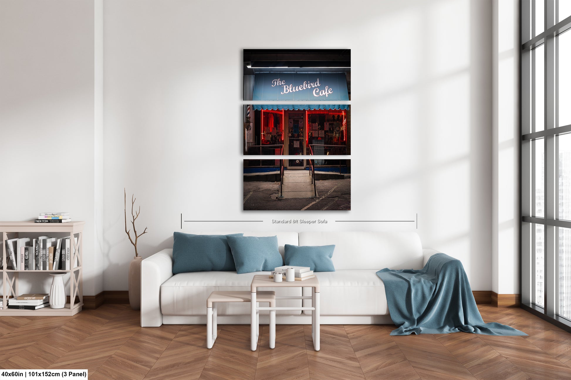 a white couch sitting in a living room next to a window