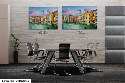 a dining room table with chairs and two pictures on the wall
