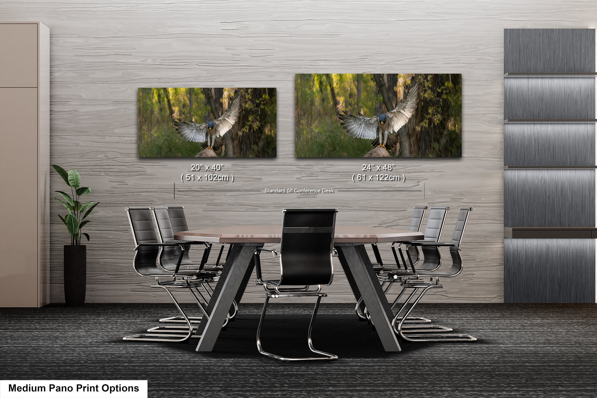 a modern office or conference room setting with a large wooden table surrounded by black chairs. Above the table, there are two framed prints of a bird in flight, which appear to be a part of the room's decor. The prints are of different sizes, with one being larger than the other. The room has a minimalist and contemporary design, with gray walls and a gray carpet.