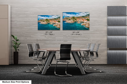 a dining room table with chairs and two pictures on the wall