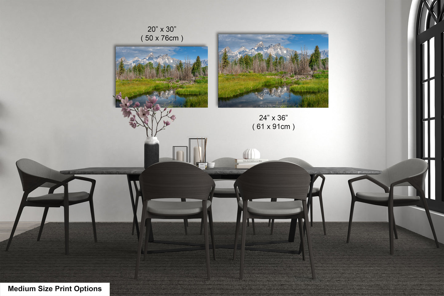 a dining table with four chairs and a vase of flowers