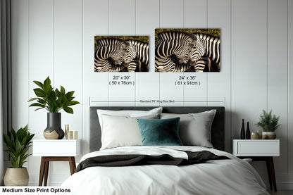 a bedroom with a bed and two zebras on the wall