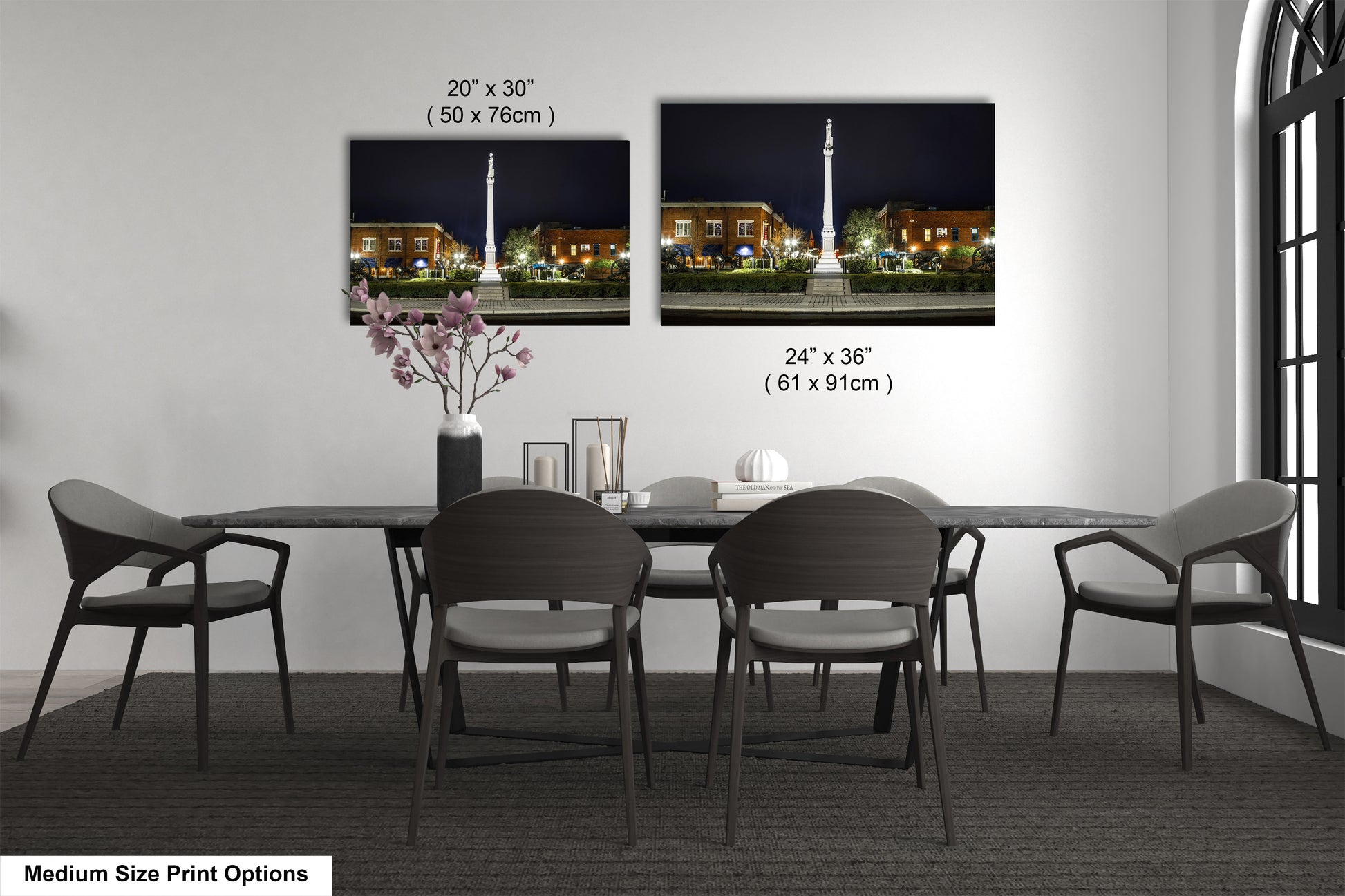 a dining room table with four chairs and a vase with flowers