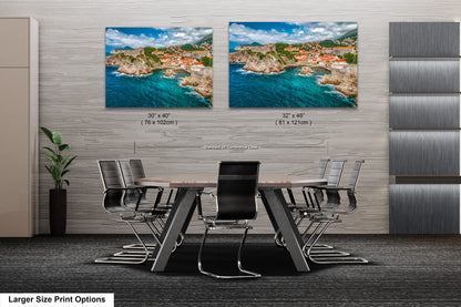 a dining room table with chairs in front of a wall with two pictures of a