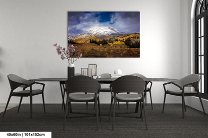 a dining room table with chairs and a painting on the wall