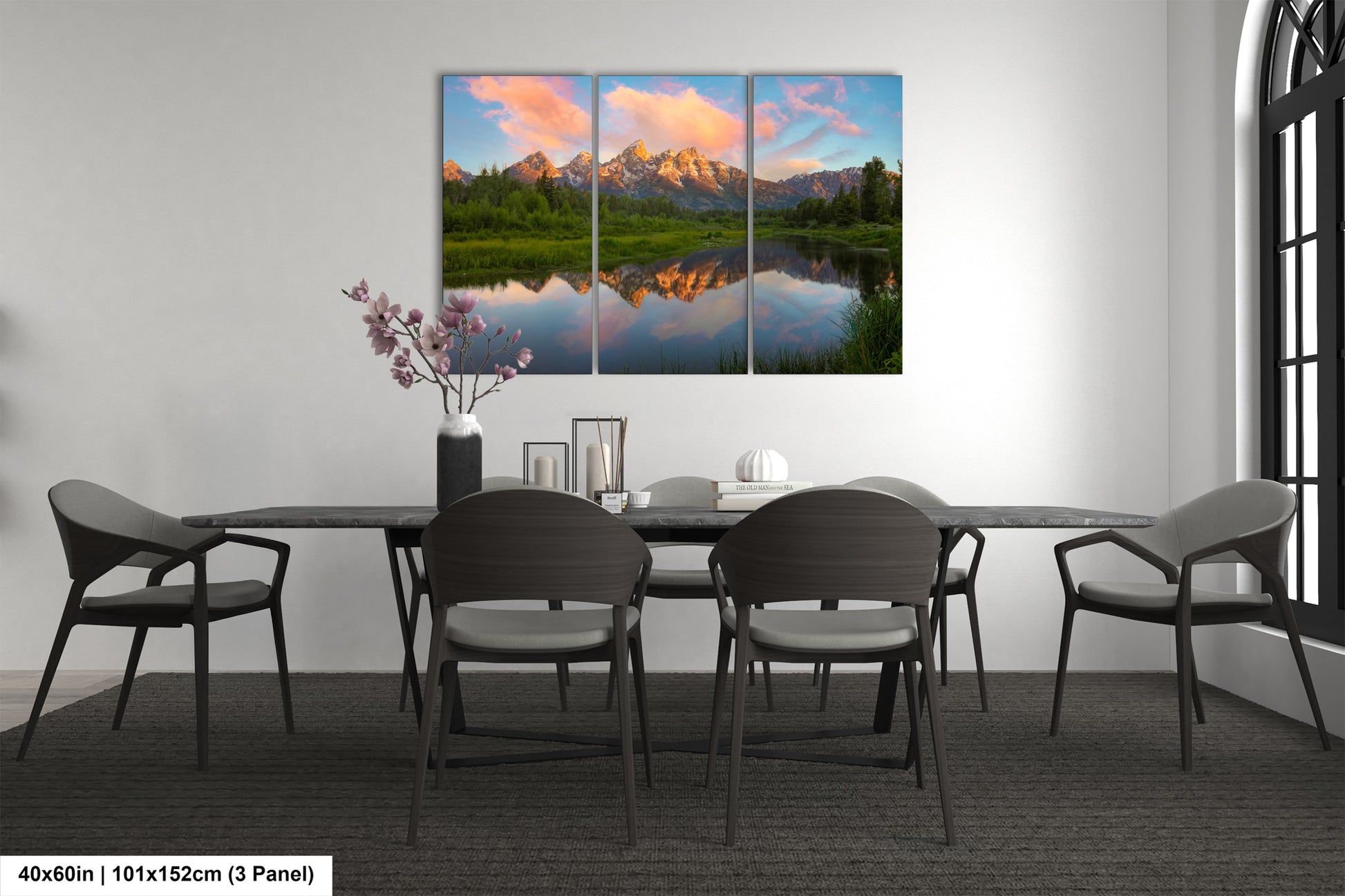 a dining room table with four chairs and a painting on the wall