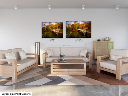 a modern living room with a large sofa, two chairs, and a coffee table. There are two framed landscape photographs hanging on the wall above the furniture.