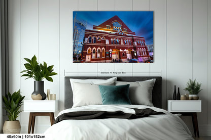 a bedroom with a bed and a painting on the wall